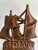 A single vintage cast iron bookend with sculpted sails and waves on a rounded base. Its aged copper-tone finish makes it a...