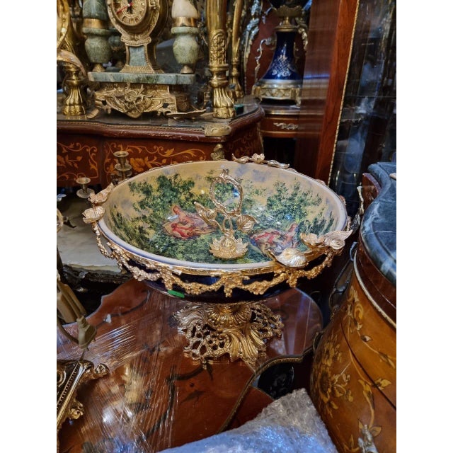 Description: An opulent French porcelain centerpiece bowl, designed in the Rococo revival style. This striking decorative...