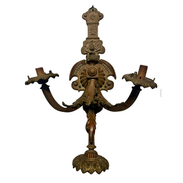 A matched pair of solid cast bronze wall sconces combining French Second Empire decorative vocabulary with American...