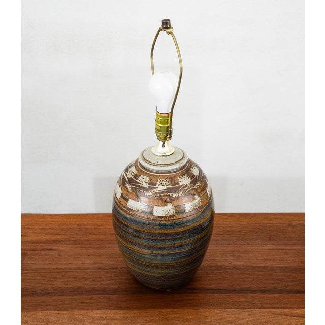 Studio ceramic blue brown and tan cylindrical table lamp. Signed beneath but unlegible to us. Stylish piece that plays...