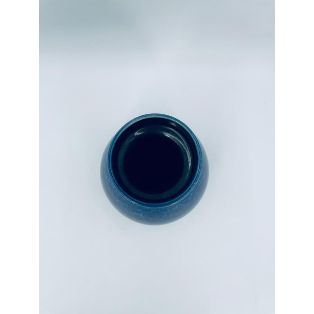 A decorative vase from Germany, dating from the 1960s/1970s, made of high-quality ceramic. The vase features a bulging,...