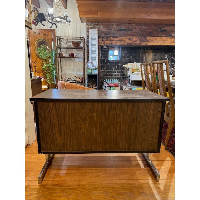 MCM Chrome & Formica Bar Cart. Features two doors with thin metal pulls and is supported by distinctive sled-style metal...