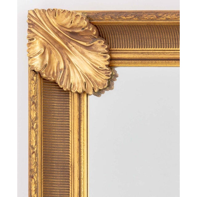 Neoclassical Style Giltwood Framed Mirror, with laurel leaf motif. Overall: 56.25" H x 42" W x 3.25" D. Provenance: The...