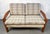 A charming mid-century Danish teak two-seat sofa featuring a sturdy, sculpted frame and classic MCM lines. The original...