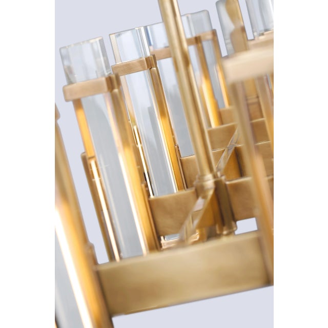 Malik Large Linear Chandelier in Hand-Rubbed Antique Brass with Crystal Designer: Ian K. Fowler Fixture Height: 15.5" Min....