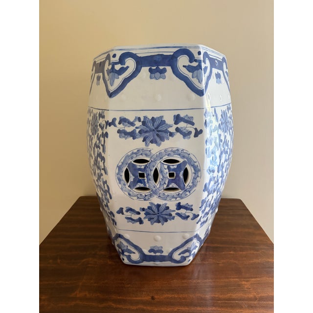 A classic blue and white porcelain garden stool, decorated with traditional Chinese motifs and stylized floral elements....