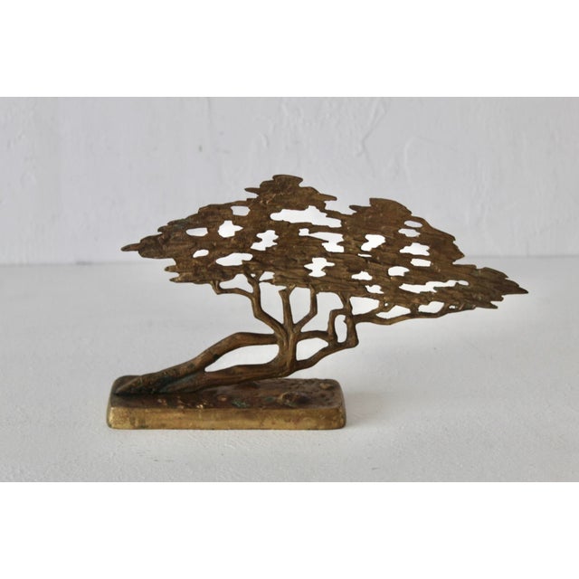 A vintage Mid-Century Modern Bijan style brass bonsai tree sculpture featuring an openwork design. Crafted from solid...