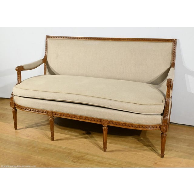 This magnificent three-seater bench in stained beech is a remarkable example of the Louis XVI style, dating from the...