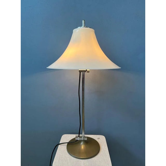 Very rare space age GEPO table lamp with white acrylic shade. The shade can be easily moved up and down the base. The lamp...