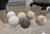 A wonderfully timeworn collection of 6 antique stone spheres, including five pale marble or limestone examples believed to...