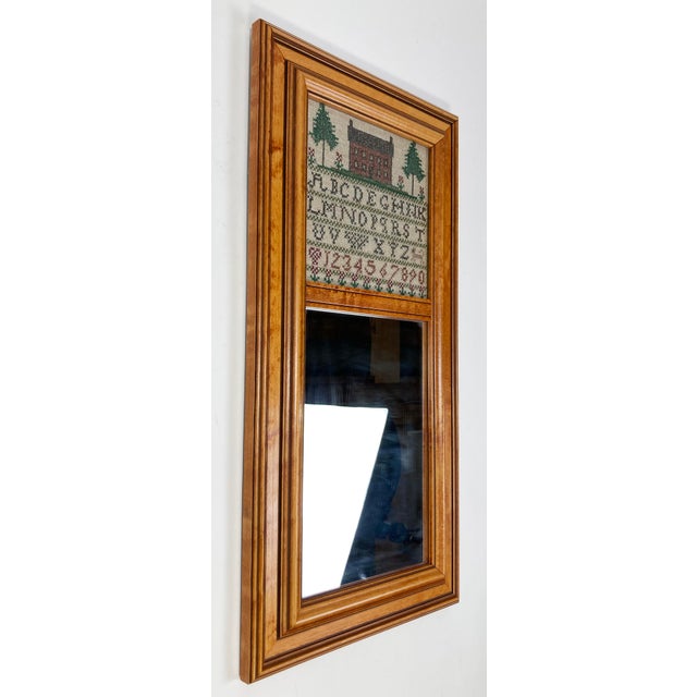 Charming vintage wood framed wall mirror featuring cross stitched alphabet and Colonial home exterior above mirror. Marked...