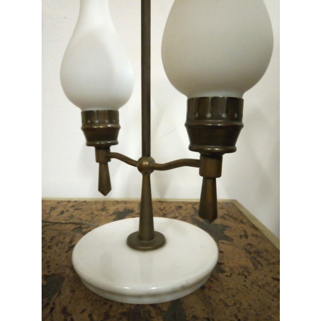 This Italian table lamp from the 1950s consists of a white marble base, a burnished brass structure, and diffusers in...