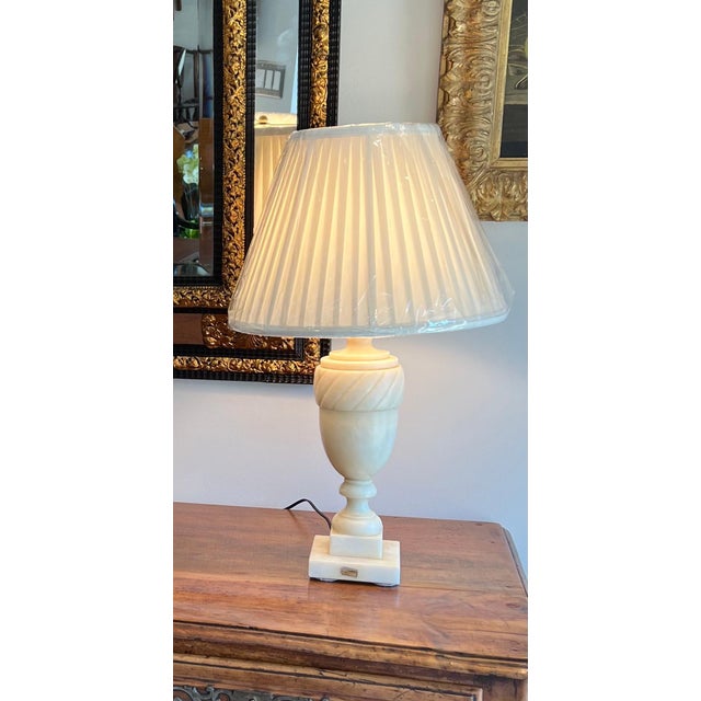 White marble urn form lamp. New half inch pleated shade. Wiring tested.
