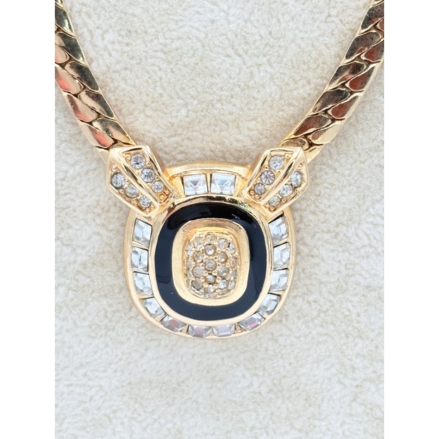 Authentic early‑1970s Christian Dior necklace featuring a geometric gold‑tone pendant framed in glossy black enamel with a...