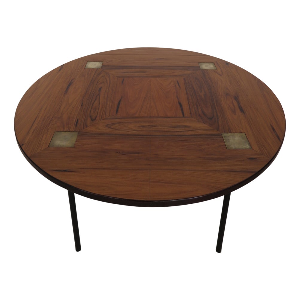 Round wooden table with a dark wood finish and a central inlaid pattern.
