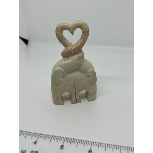 Carved stone elephants with their trunks entwined to form a heart. Perfect for the elephant lover in your life. The stone...