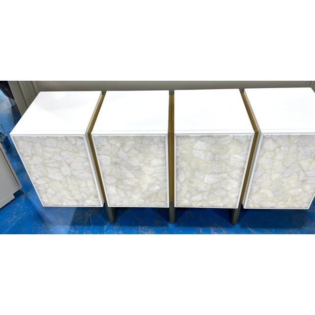 Original retail $8847, stylish Baker Modern Quartz White and Brass Kira Credenza, four doors, showroom floor sample