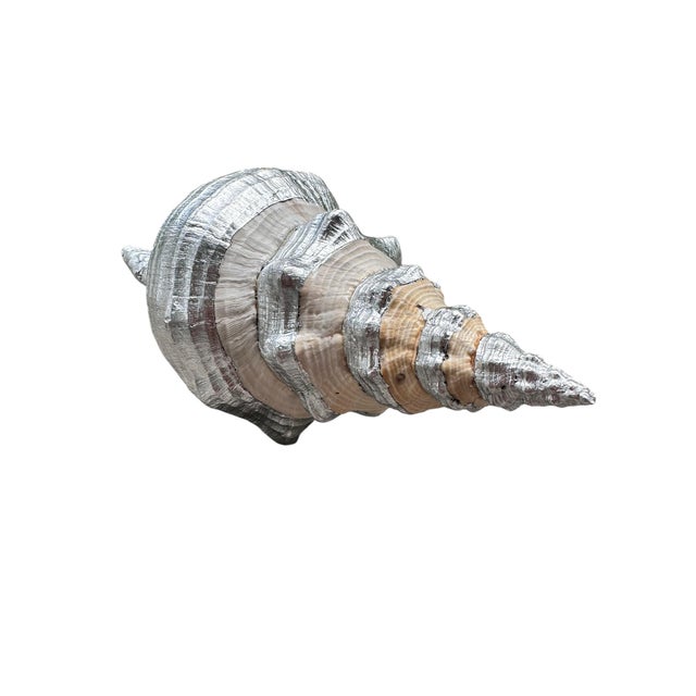 A sculptural, oversized horse conch shell reimagined as a refined decorative object, finished by hand with luminous silver...