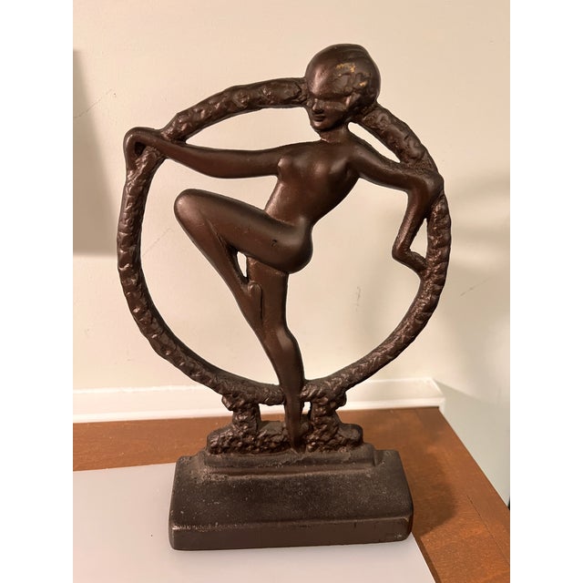 Cast-Iron Art Deco bookends (pair) produced by Seville Studios and imprinted with mold #S-208. The design is referred to...