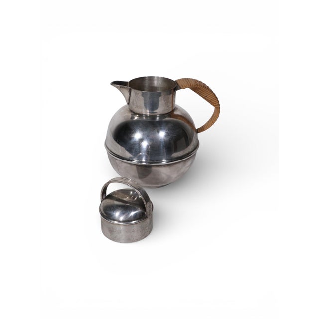 Chic individual silver plate tea, or chocolate pot, with rattan wrapped handle. This example is in very good, original...