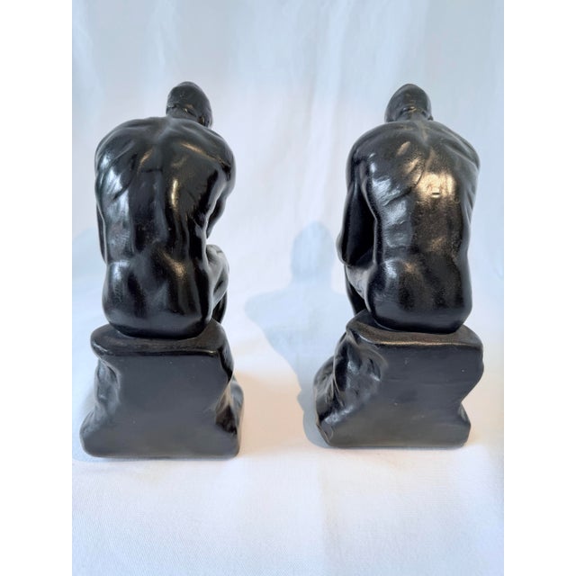 Pair of Armor Bronze (Bronze over cast metal) Replica of Auguste Rodin's famous sculpture, The Thinker. Dark patina gives...