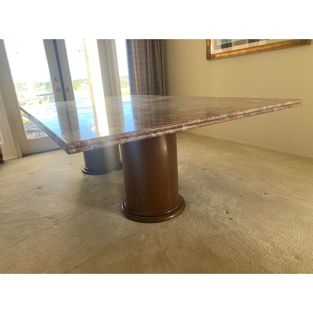 Striking custom dining table featuring a luxurious Italian marble top set on a sculptural cherry wood base. Neutral color...