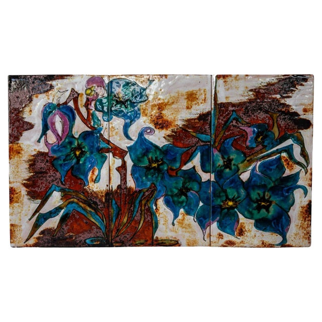 Incredibly beautiful flower arrangement on a ceramic tile with a gloss of glaze in the brightly colors blue, pink and...