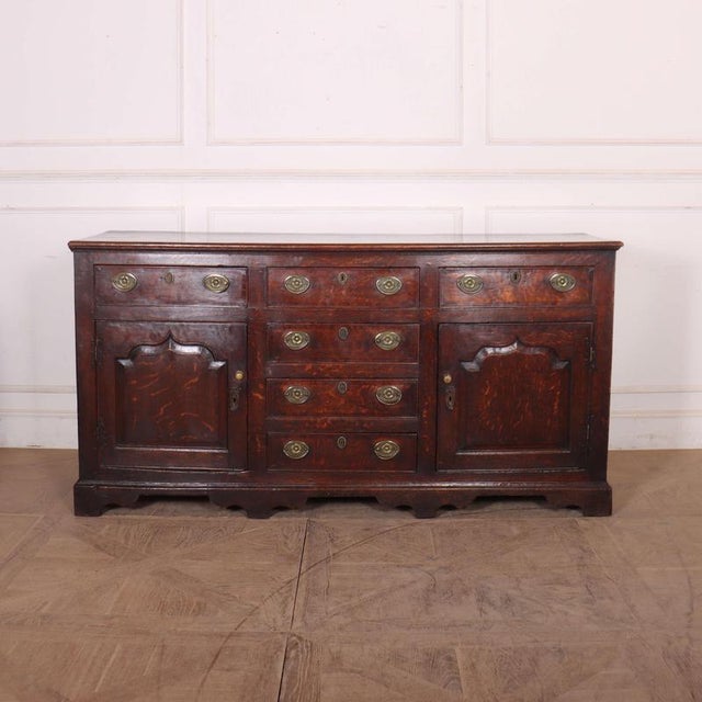 Stunning late 18th C English oak dresser base with carved fielded panels and a wonderful colour. 1790 This piece is...