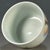 This is a striking vintage Chinese porcelain teacup, decorated in the famille rose palette with vibrant polychrome...