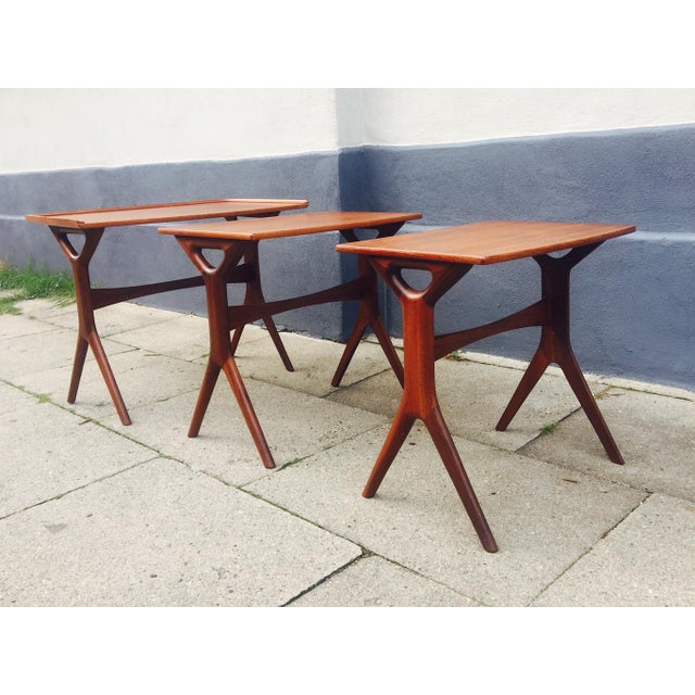 This full set of nesting tables designed by Johannes Andersen for CFC Silkeborg has X-shaped legs made of solid teak and...