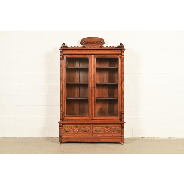 An exceptional antique Eastlake Victorian bookcase cabinet In the manner of Herter Brothers USA, Circa 1880s Carved...