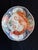 A finely painted Japanese Imari porcelain dish dating to the late Edo to early Meiji period, featuring a dynamic phoenix...
