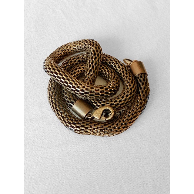 Vintage 1980s flexible mesh collar necklace featuring a substantial tubular weave with an aged bronze-tone finish and...