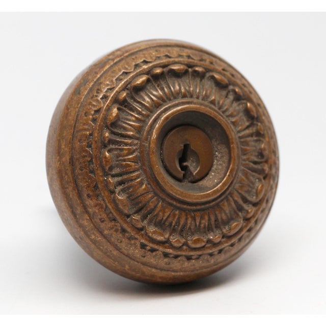 Radial design knob made of bronze with a center keyhole. No key is included. The manufacturer and date of creation is...
