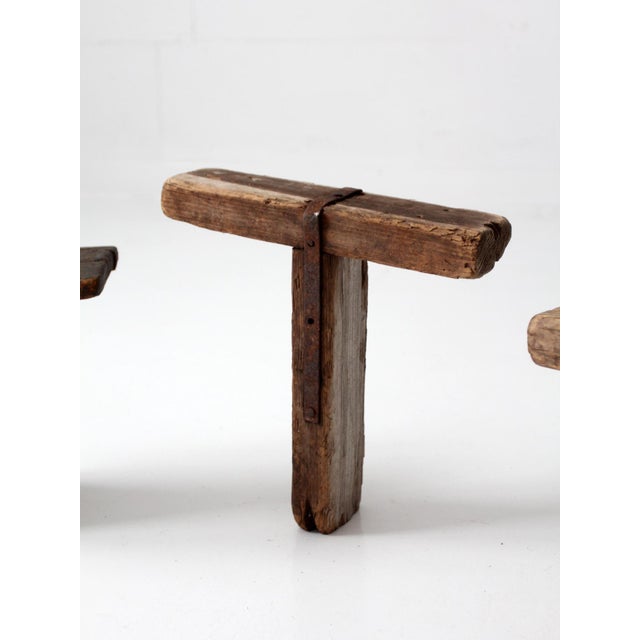 Collection of three 19th-century Primitive Americana milking stools, each featuring a distinct hand-built form shaped by...