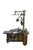 Detailed scrap-metal sculpture features a whimsical surgical scene crafted entirely from upcycled industrial hardware. On...