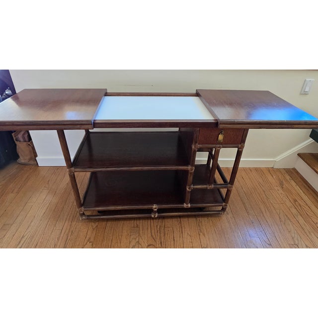 1970's era bamboo and solid wood rolling bar cart, server, sideboard, or buffet featuring an expandable top. Genuine...