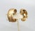 1950s goldtone curled C shaped with textured outside and smooth inside clip earrings. Marked "NAPIER PAT. PEND." Measure:...