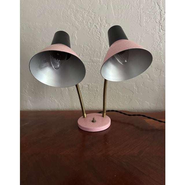 A fabulous midcentury piece! This dual light desk lamp has two pink metal cones with gold sparkles attached to a black...