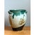 This pottery vase presents a rounded, urn-like silhouette, its body curving gently outward from a narrower base to a...