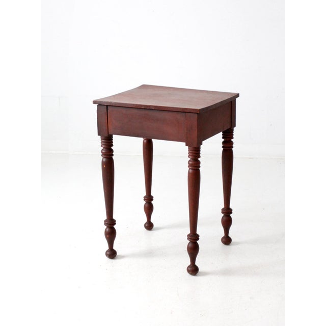 This antique Federal Revival side table, dating to the late 19th century, showcases a simple yet elegant design. The...