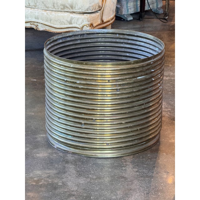 Cylindrical brass pot with closely spaced reeded rings running the full height of the body, giving it a strong, textural...