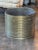 Cylindrical brass pot with closely spaced reeded rings running the full height of the body, giving it a strong, textural...