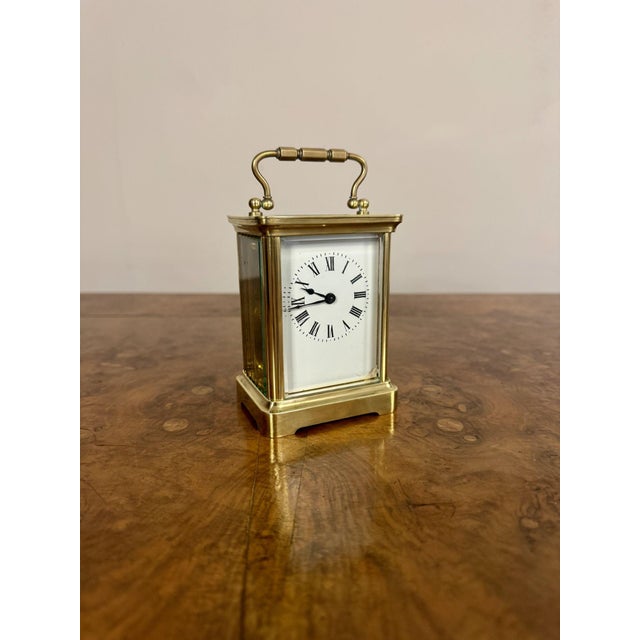 Quality antique Victorian brass carriage clock having a quality brass case with bevelled glass, a white enamel dial with...