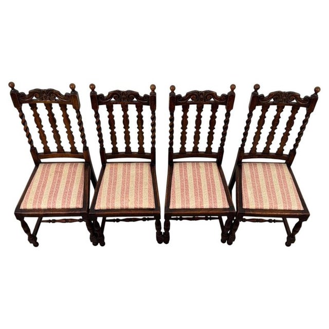 A handsome and well-crafted set of four 20th-century oak dining chairs, combining traditional barley twist detailing,...