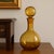 Elevate your barware or home decor with this stunning Mid-Century Modern amber glass decanter, attributed to the Empoli...
