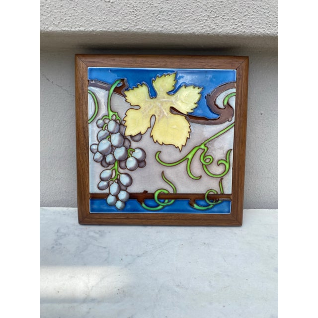 Art Nouveau Majolica trivet in a footed wood frame, circa 1900. Grapes pattern. 7.5" by 7.5"
