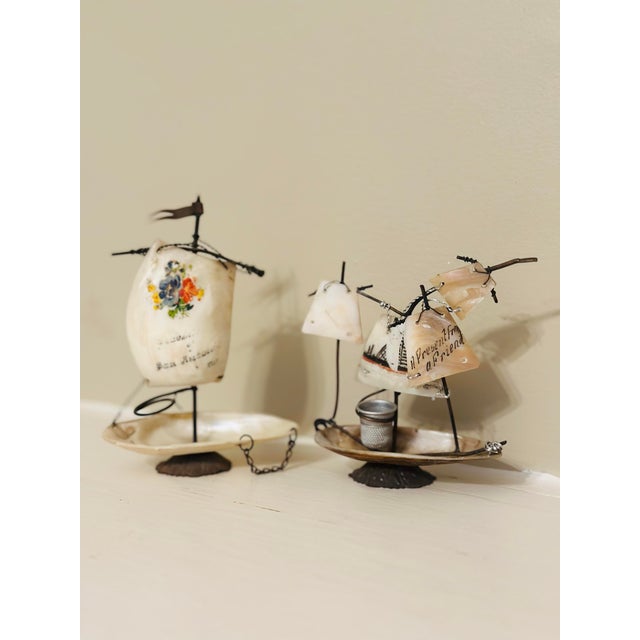 Pair of Vintage Shell Sailboat Folk Art Sculptures A charming pair of vintage handcrafted shell sailboats featuring...