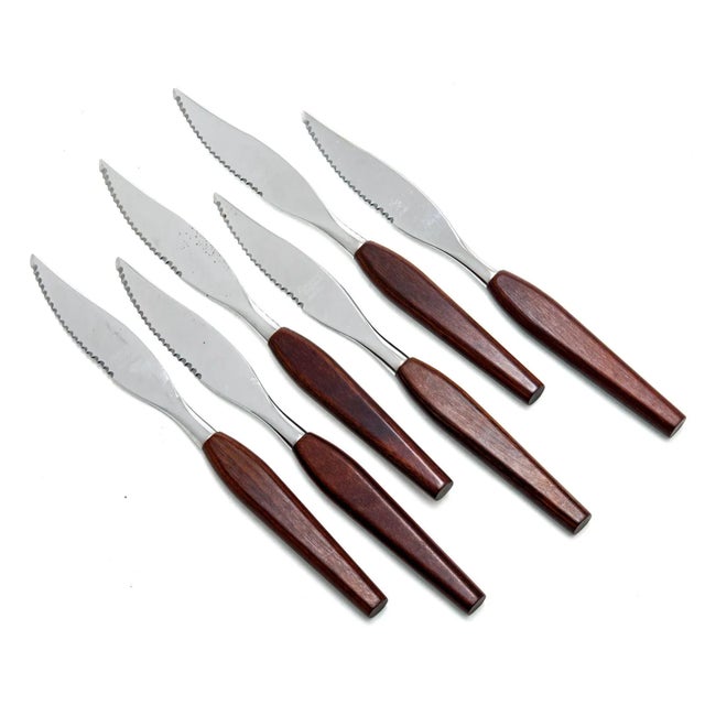 Danish Steak Knives Danish modern and elegantly shaped steak knives feature warm wood handles and serrated high-gloss...
