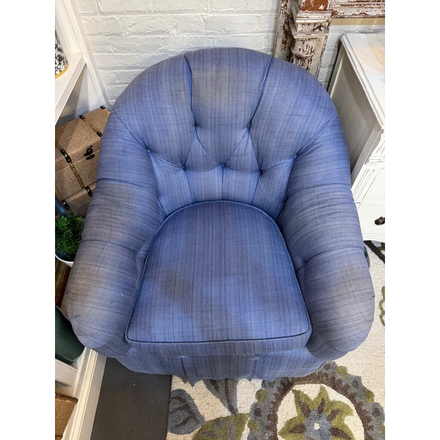 This is a club chair. It also is able to swivel. It is made by Kravet furniture. It has a woven linen fabric in a blue...